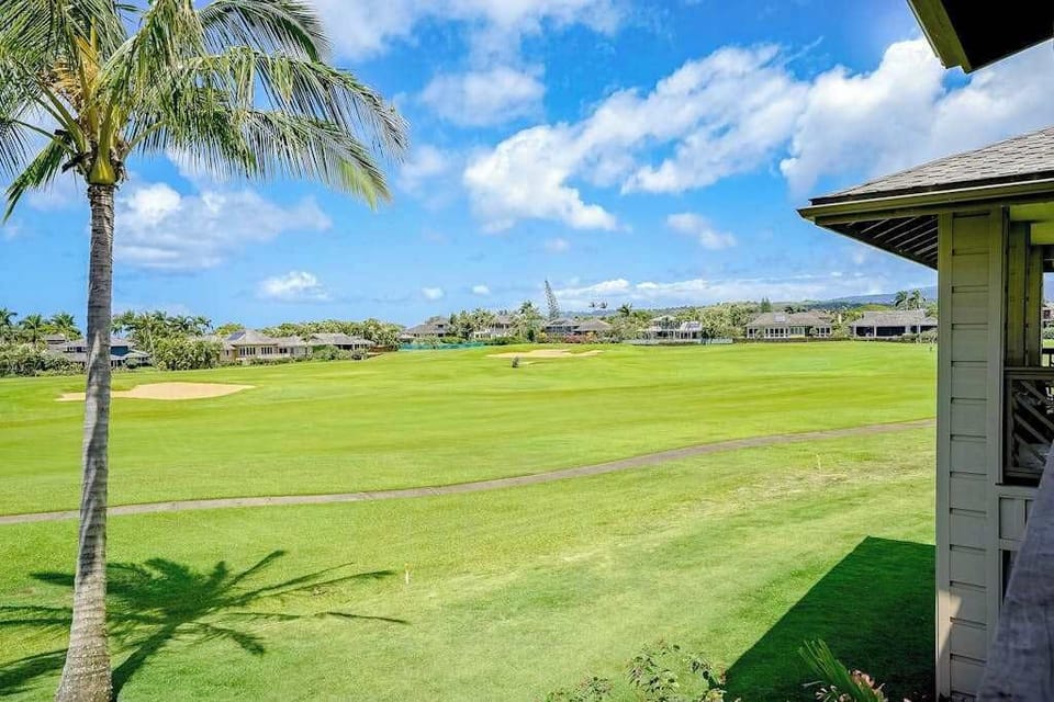 Pili Mai Resort with lush tropical views and swaying palm trees.