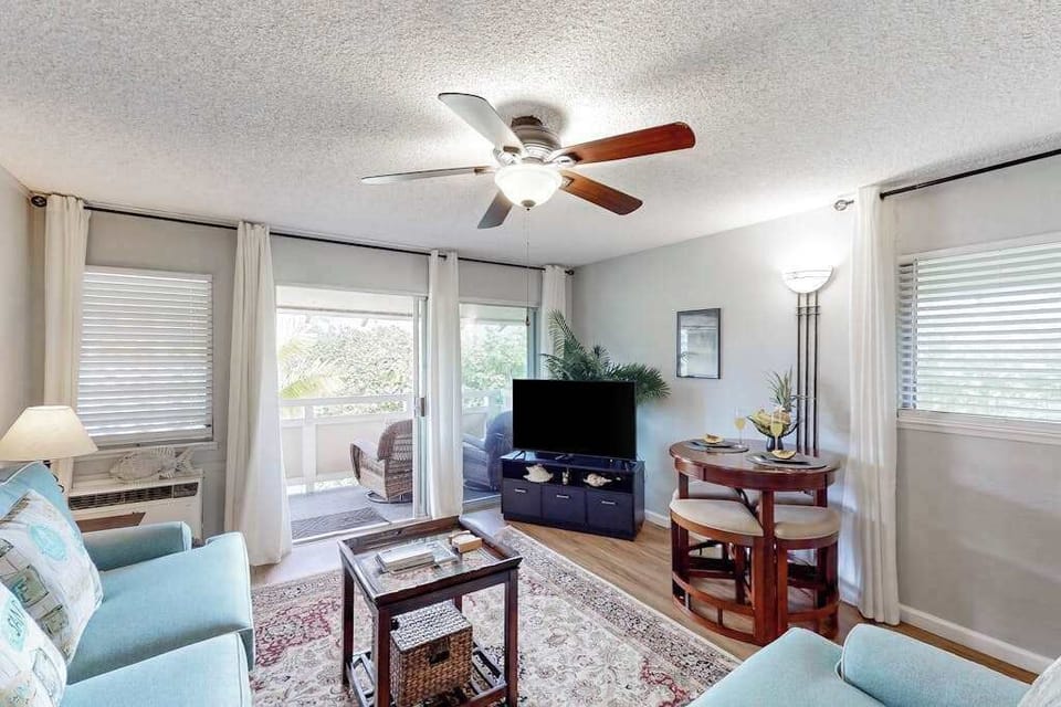 The living area seamlessly opens onto a private lanai with comfortable seating and impressive views of the mountains and surrounding landscape.