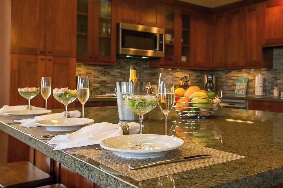 High-end and high-style, the open kitchen boasts handsome cherry cabinets, granite counters, stainless appliances, and a large island with seating for three. 