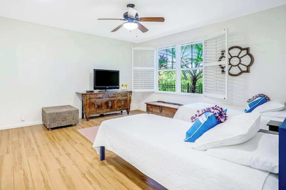 Extra living area with two single beds and a flat screen tv.