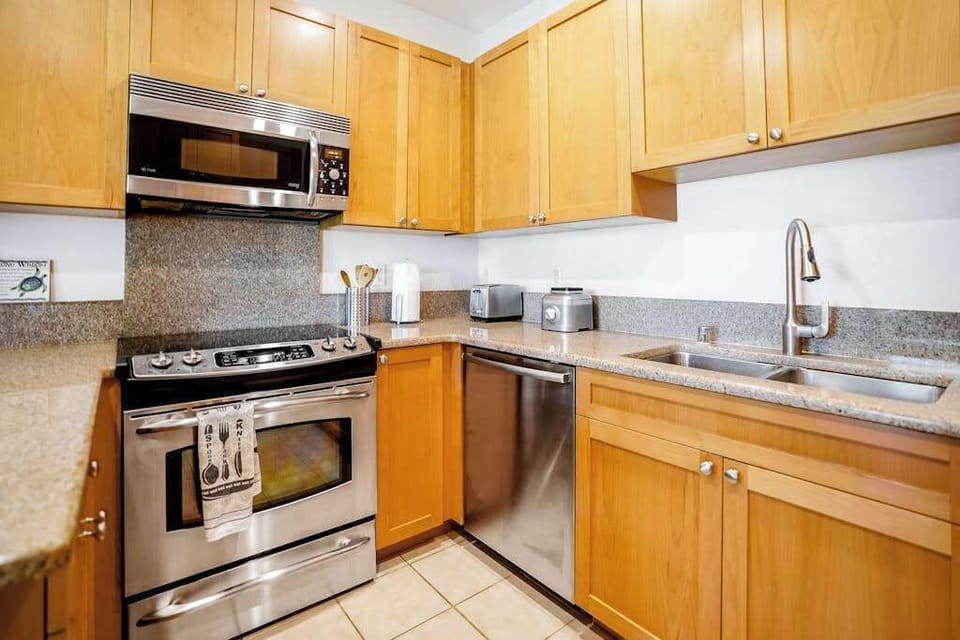 Fully-equipped kitchen, which is complete with all the modern appliances to make cooking a breeze, including a French-door fridge, stove, oven, dishwasher, microwave, and coffee maker.