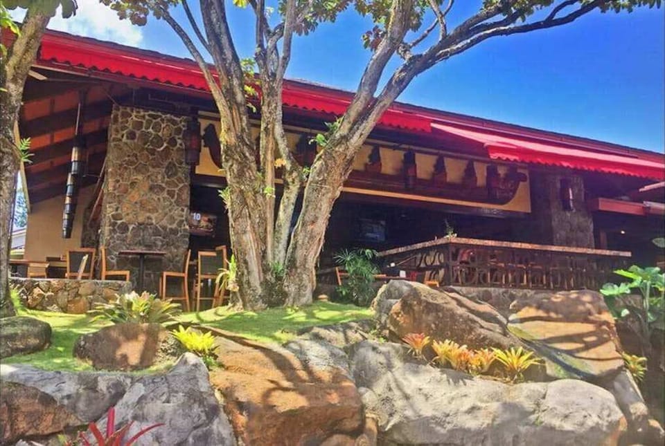Welcoming resort entrance showcases warm island charm and natural surroundings