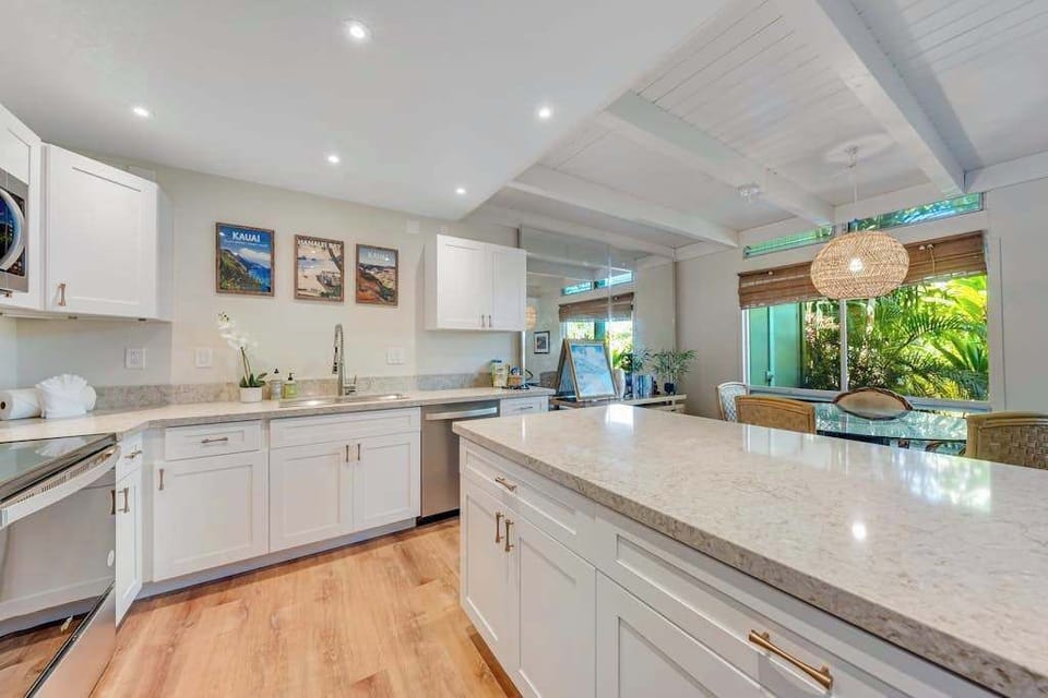Modern open-concept kitchen featuring sleek stainless steel appliances, expansive countertops, and plenty of workspace for preparing everything from quick breakfasts to gourmet meals.