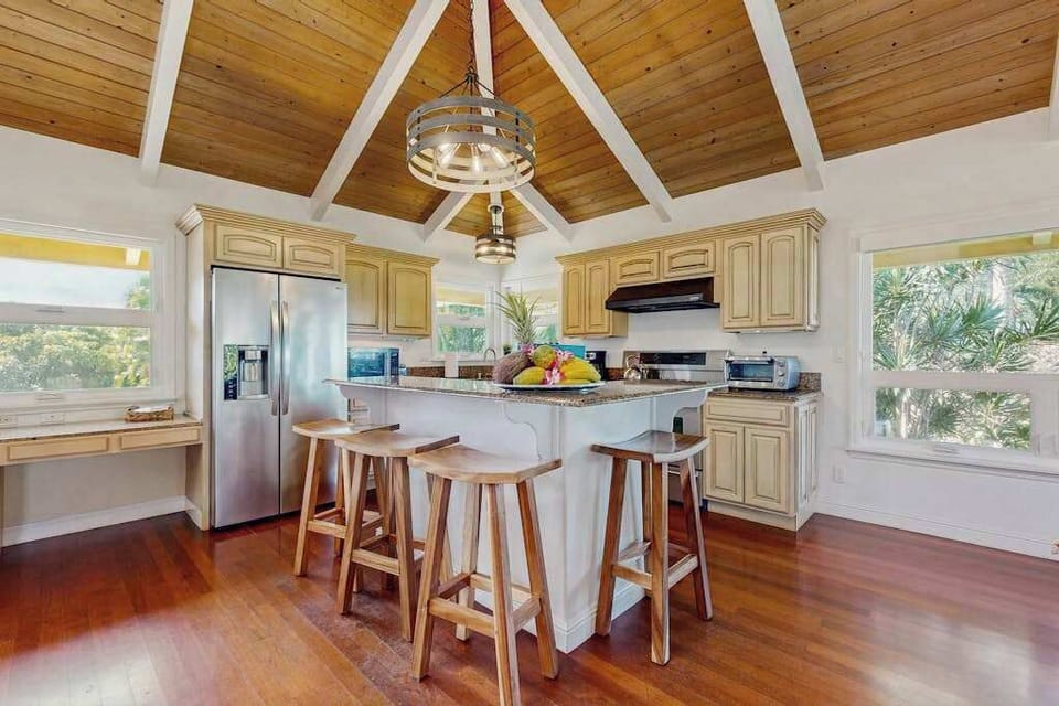  The kitchen is equipped with plenty of equipment to cook delicious meals, as well as luxuries like a kitchen island and a brand new stainless steel French door refrigerator. 