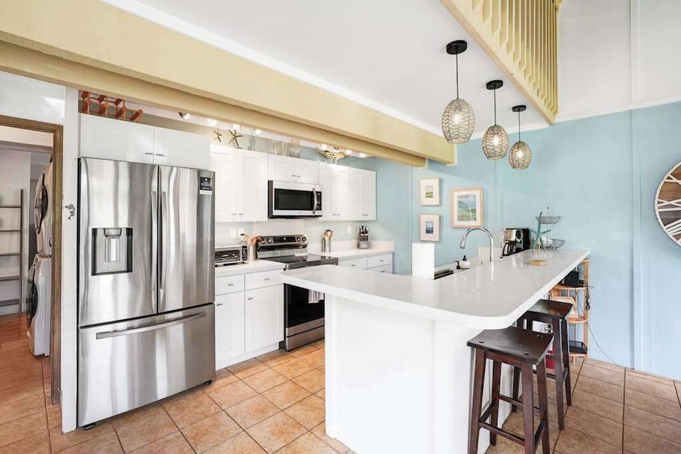 Newly remodeled modern kitchen featuring stainless steel appliances and an island for extra counter space.