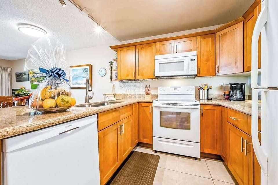 Kitchen appliances and wood cabinetry create welcoming meal preparation space
