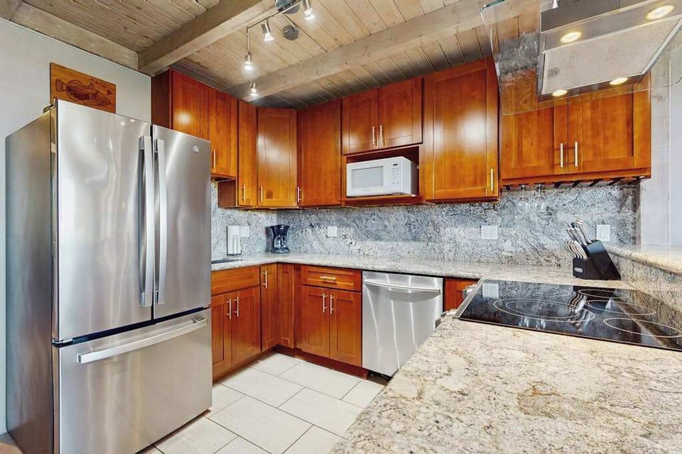 Warm kitchen showcases granite counters, practical storage, and updated appliances