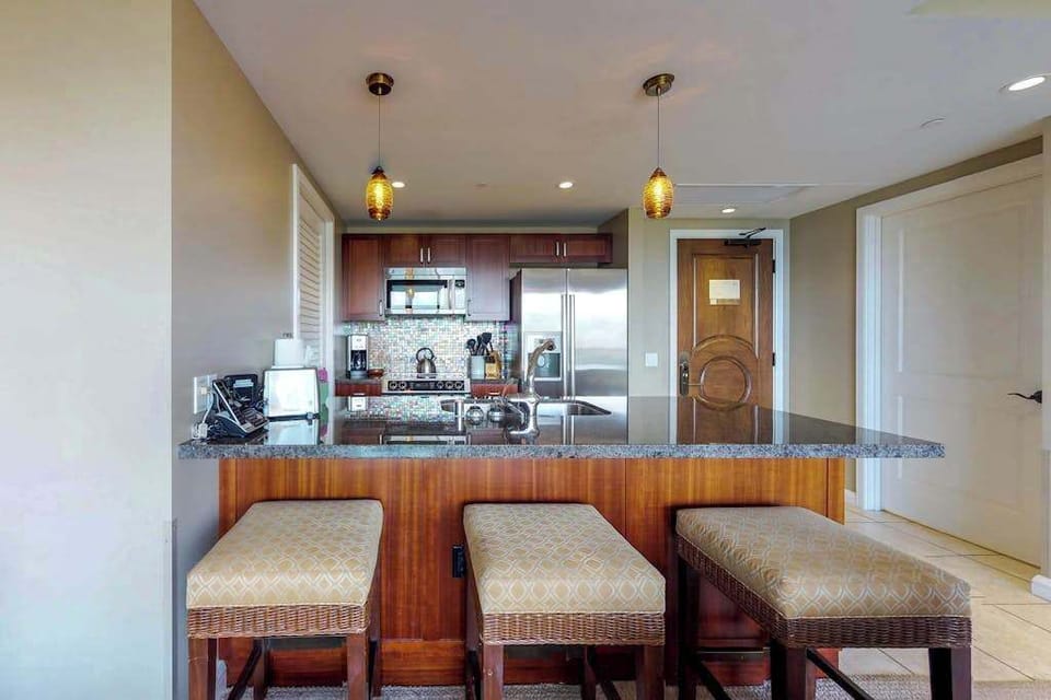 Kitchen island with comfortable bar stools, perfect for sharing casual meals or enjoying a few drinks together.