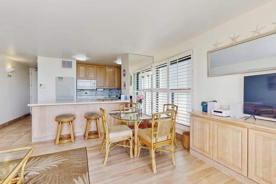 Dining room with seating for four and extra seating at the kitchen counter.