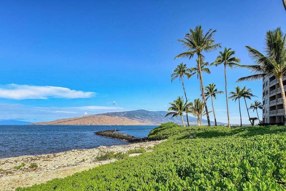 Crystal-clear turquoise waters gently wash onto pristine white sandy beaches.