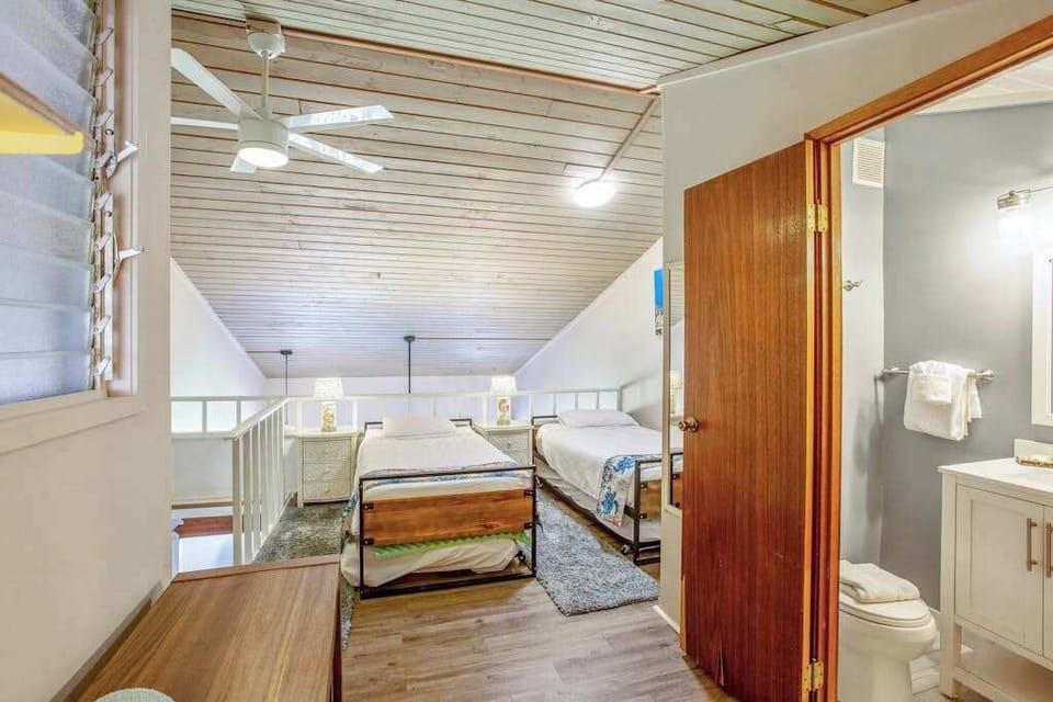 Three single beds located in the loft of the townhome.