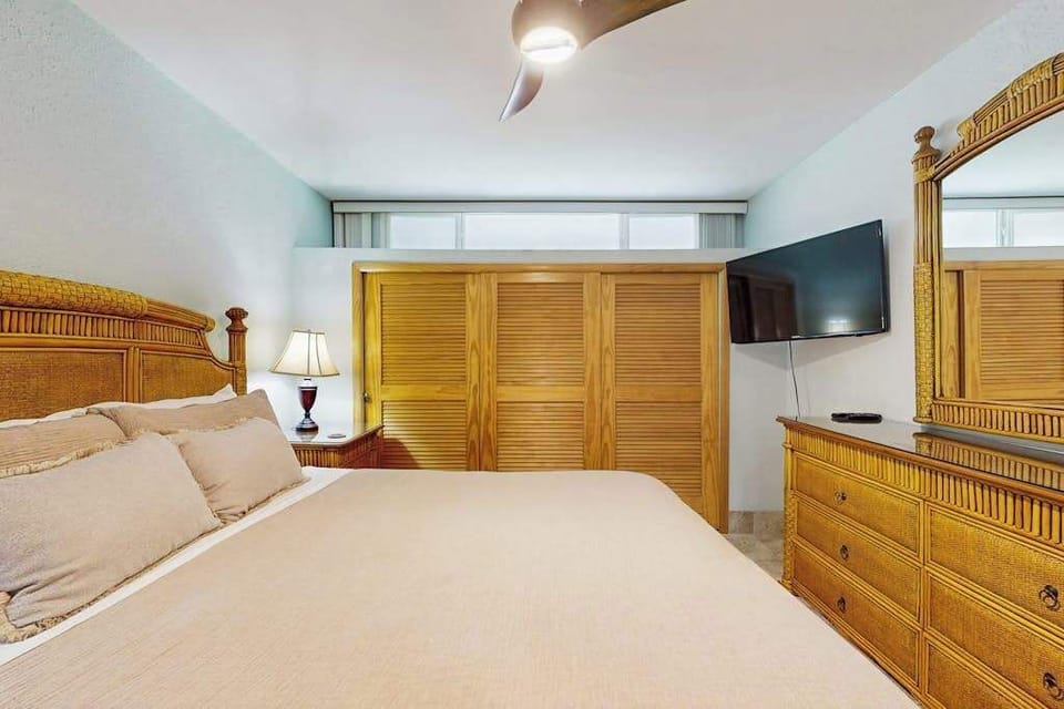 Comfortable bedroom with a king bed and flat-screen TV for restful nights and relaxing mornings.