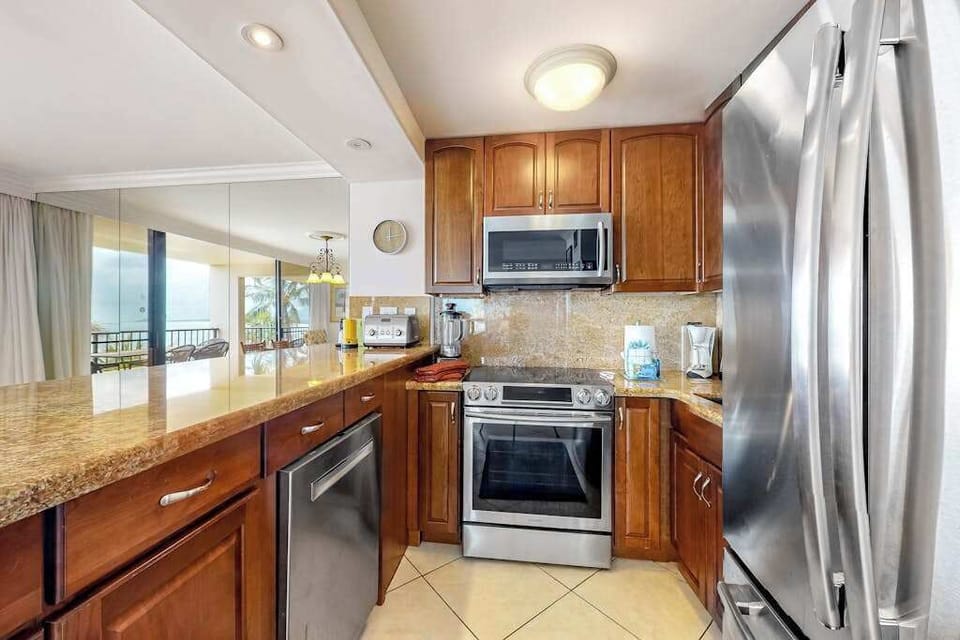 This newly remodeled kitchen with stainless steel appliances.  Large kitchen countertop for all the chef's prep needs and open to the dining room so that you are always with your company.