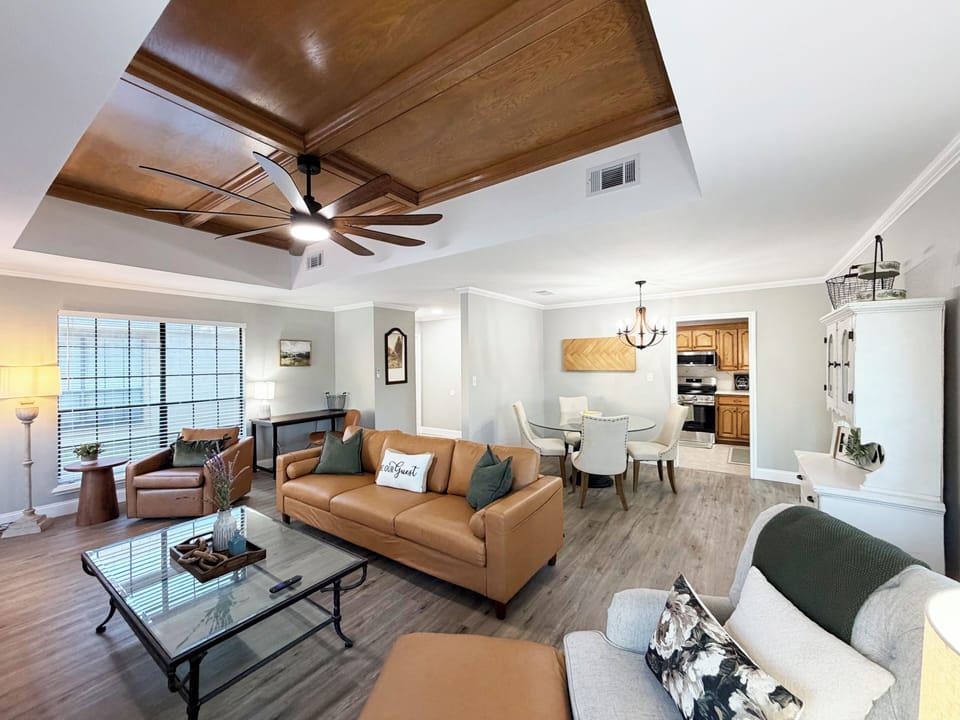 Bright open living space with stylish seating and a stunning wood ceiling