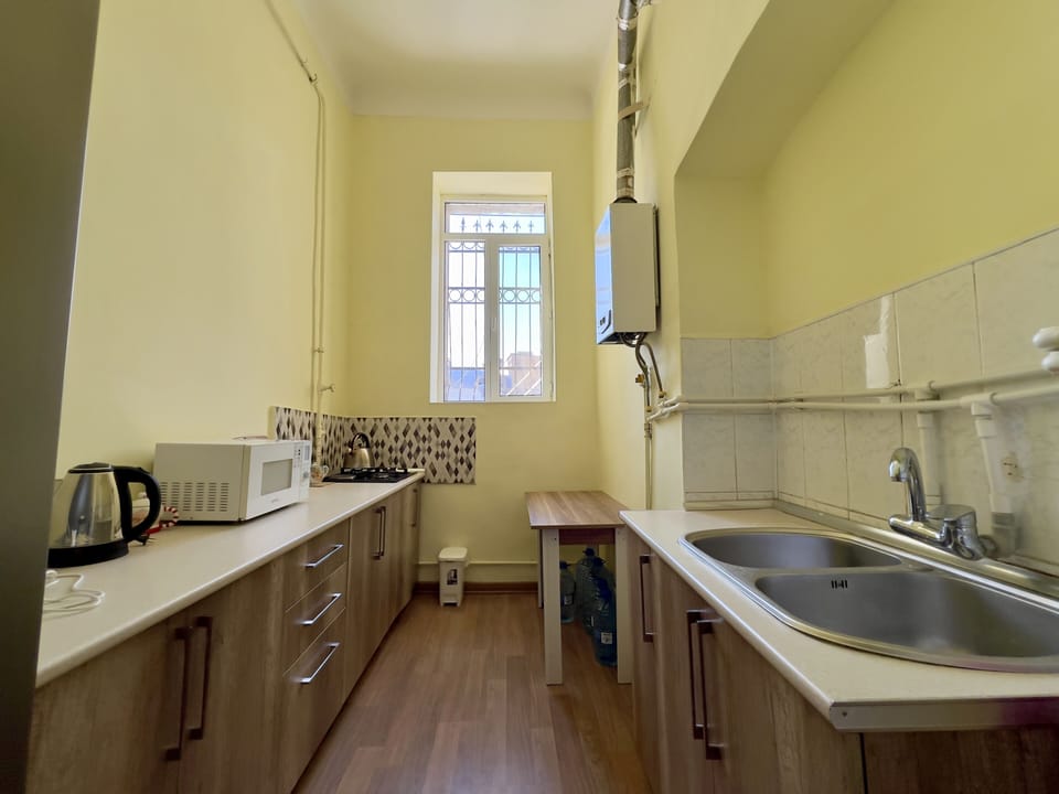 Full kitchen with refrigerator, cooktop, microwave, and sink