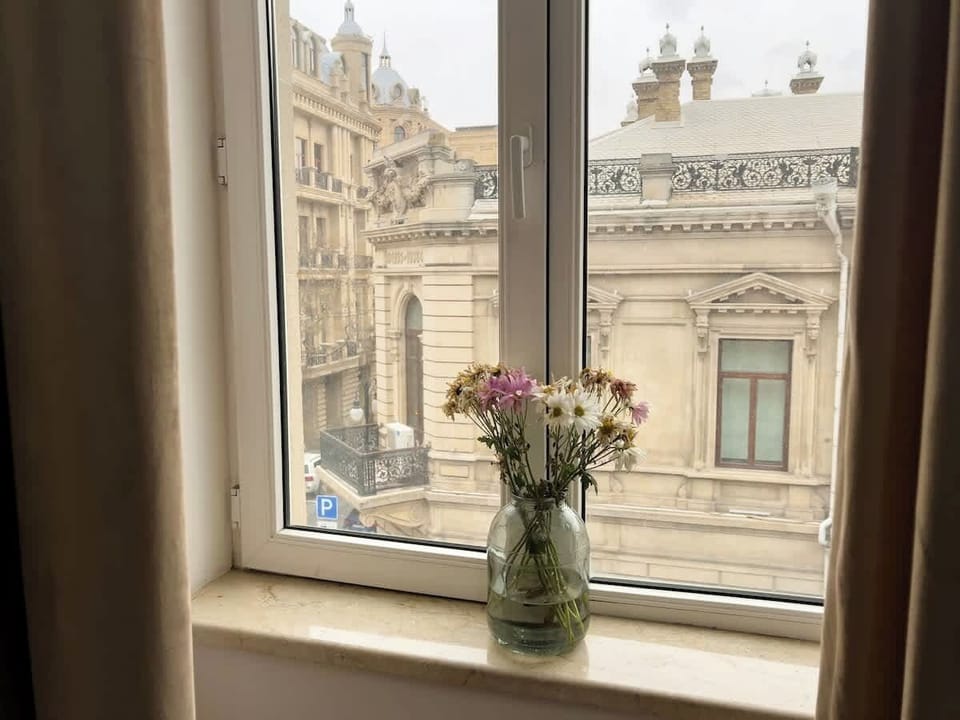 Bright window overlooking central Baku architecture.