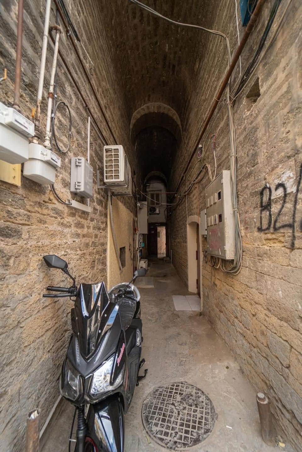 Stone-vaulted corridor leading to the apartment's private entrance.