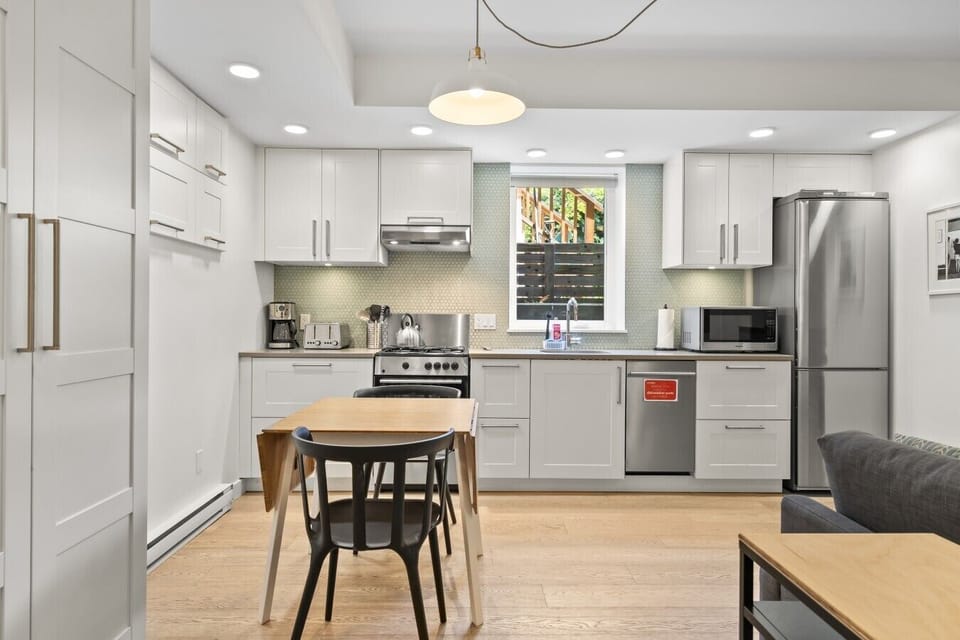 Modern Kitchen: Sleek appliances and vibrant decor make cooking a delight in this stylish space!