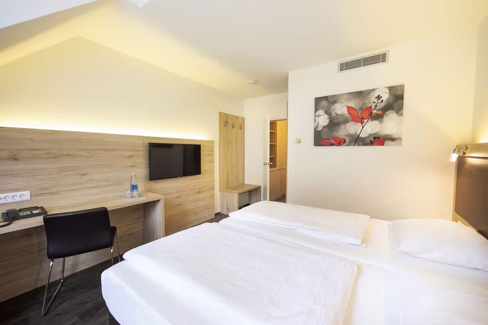 Settle in with cozy bedding, TV entertainment, and workspace.