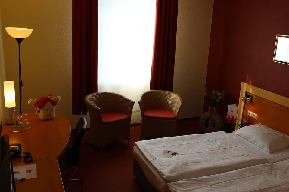 Recharge in a quiet corner with comfortable seating by window.
