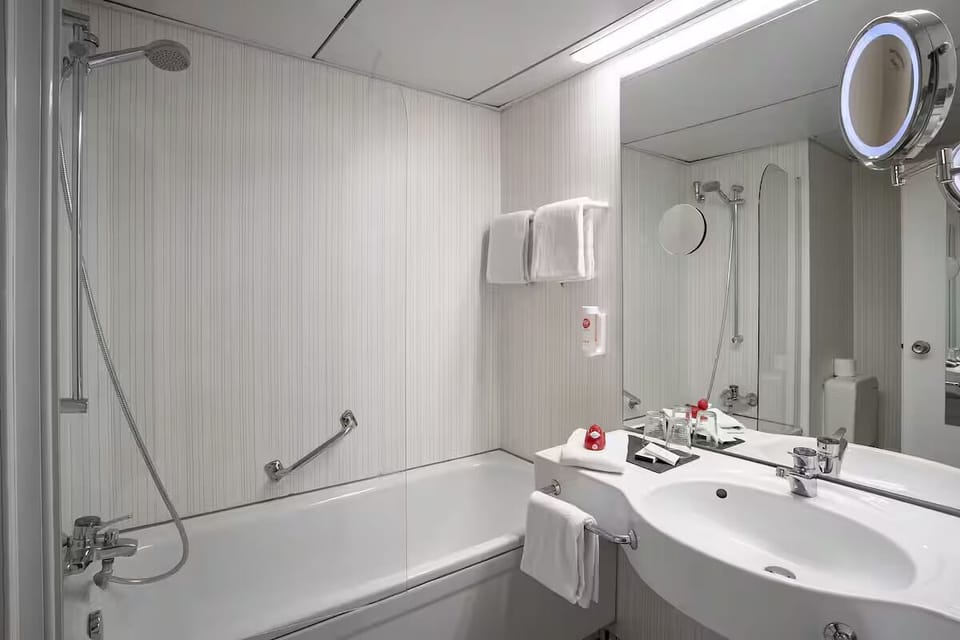 Refresh effortlessly in a spotless bath with bright vanity mirror.