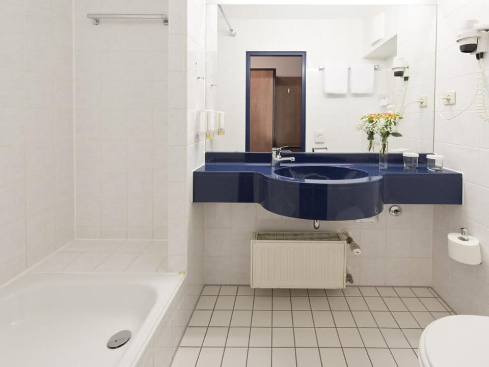 Refresh easily in a spotless bath with spacious vanity.