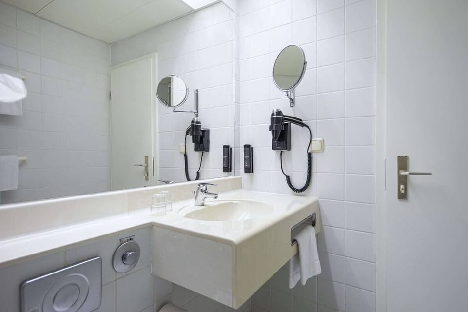 Get ready with a spacious mirror and bright vanity lighting.