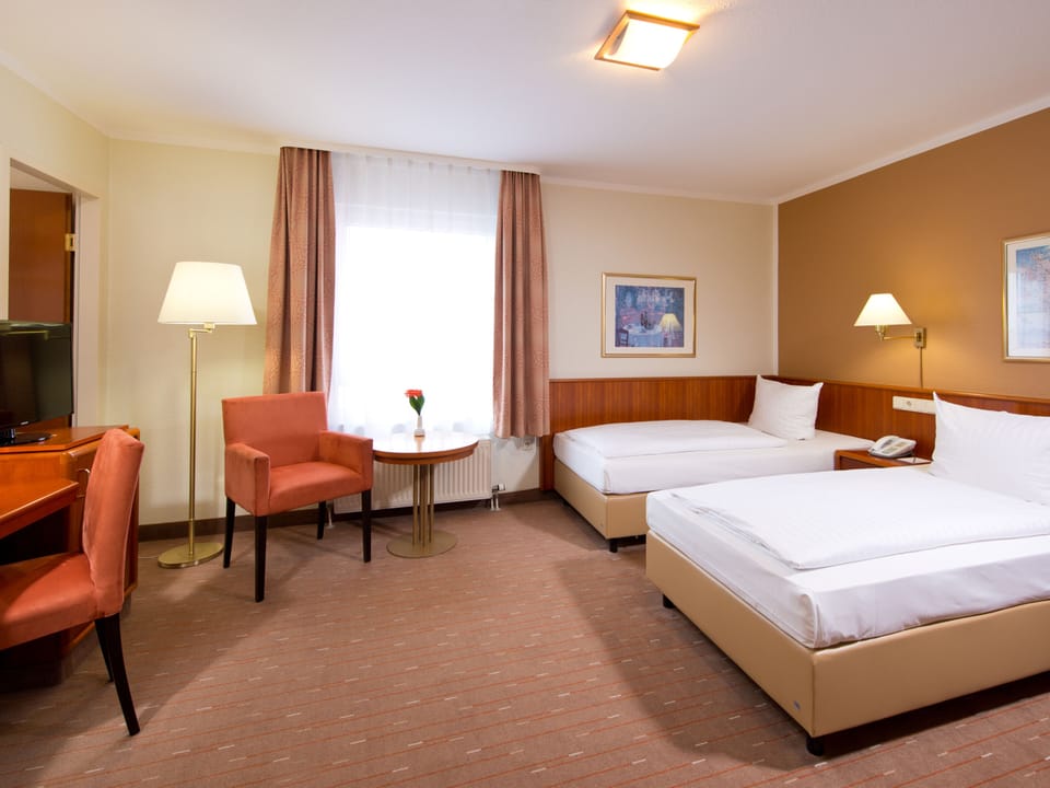 Sink into crisp bedding and relax in a warm, spacious room.