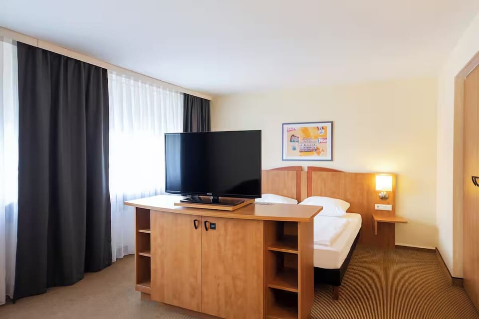Settle in with blackout curtains, airy daylight, and comfortable bedding.
