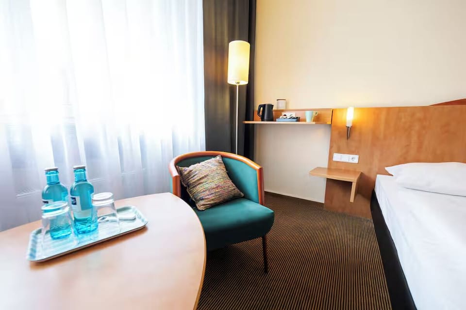Lounge with sparkling water and relax beside sheer curtains.