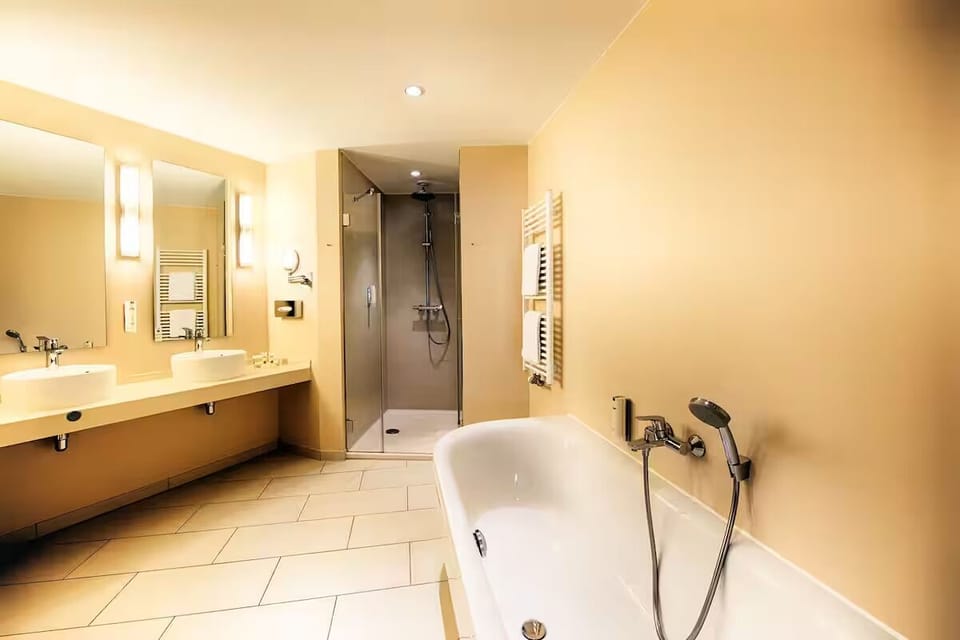 Refresh in a spacious bath with tub and walk-in shower.