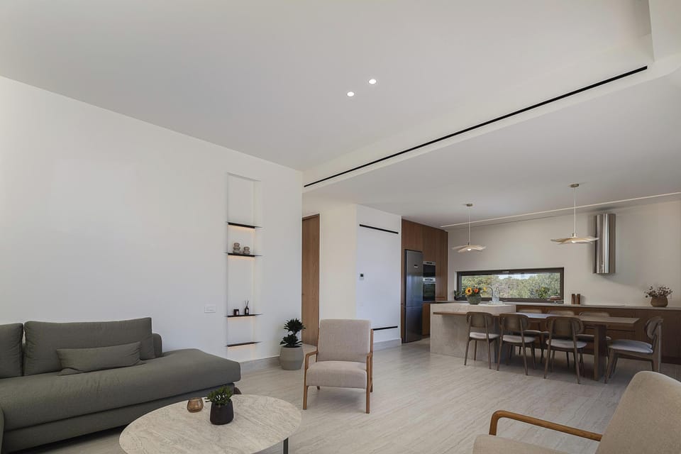 Comfortable and inviting living area with large openings, offering relaxing views and a perfect setting for entertainment.