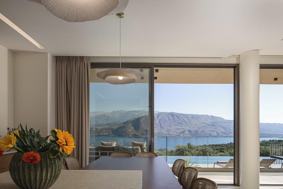 Modern open-plan living space with natural light, cozy seating, and seamless indoor-outdoor connection.