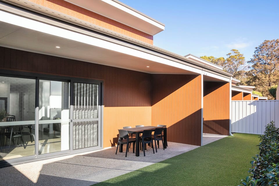 Private covered patio with outdoor dining and fenced yard space