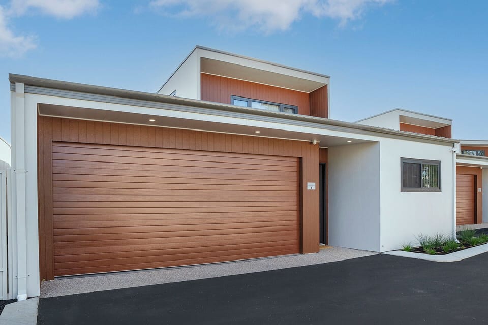 Modern townhouse exterior with double garage and sleek contemporary design