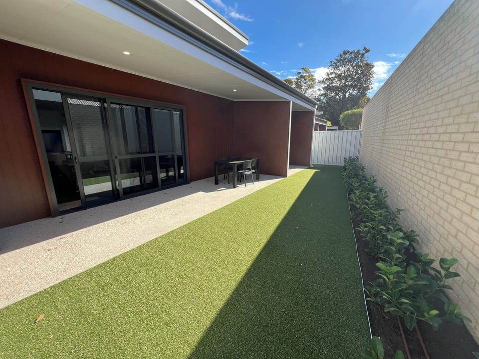 Modern covered patio & turf yard—private, low‑maintenance retreat