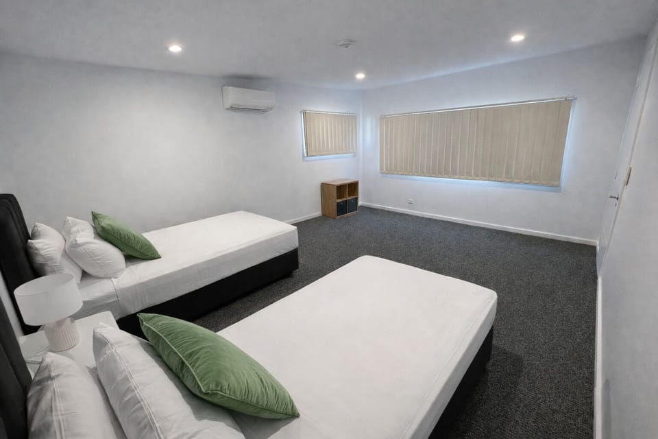Spacious twin-bed room with AC, blackout blinds, and calm vibes