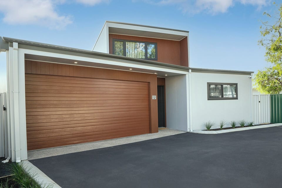 Modern townhouse exterior with garage, private entry, and easy parking
