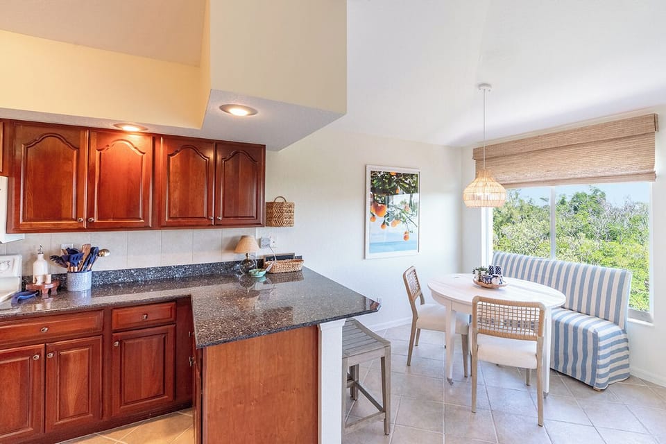 Breakfast nook has a place for everyone to gather - a table with bench seating and a breakfast bar with 3 stools