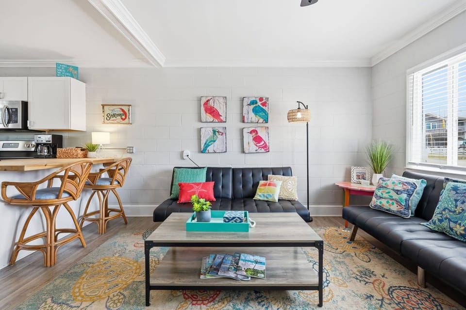 Sink into plush seating and soak in the cheerful beach vibes—your home away from home features a stylish open-concept layout where you can relax, dine, and make memories together.