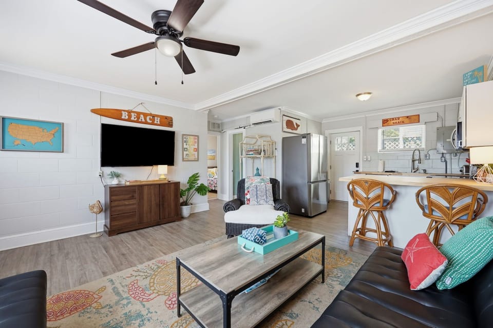Relax in your bright, beachy living space with coastal décor, comfy seating, and a full kitchen with a breakfast bar—perfect for unwinding after a day exploring the shore.