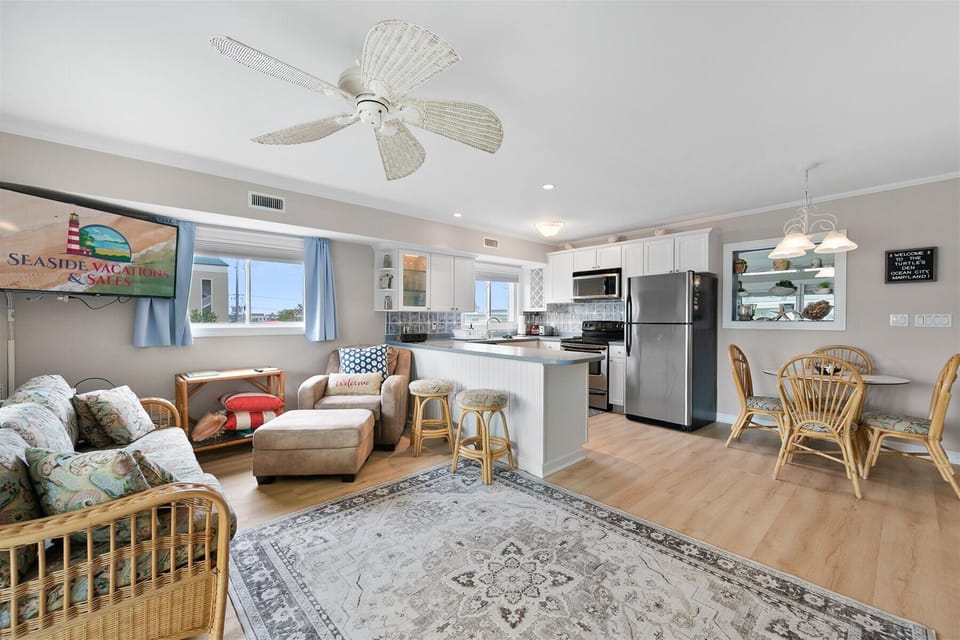 Relax in style with a living space that seamlessly flows right into the modern, fully equipped kitchen.
