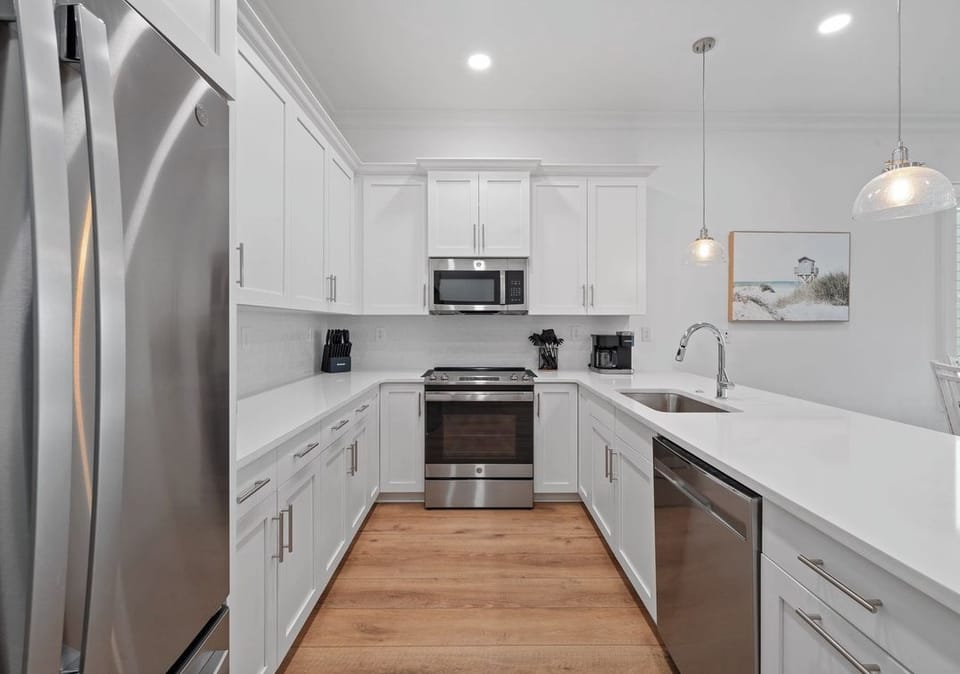 Fully equipped kitchen with stainless steel appliances and ample counter space.