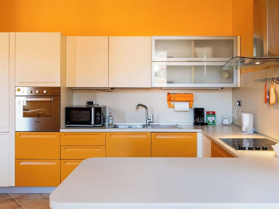 Kitchen, Countertop, Kitchen Appliance, Cabinetry, Interior Design, Furniture, Major Appliance, Wood, Yellow, Orange