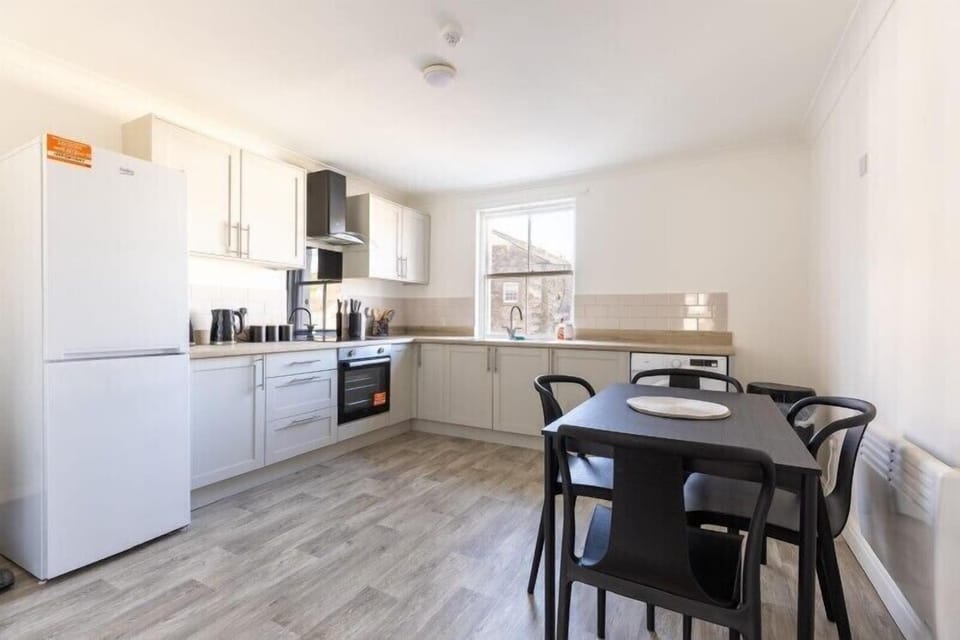Spacious, spotless open-plan kitchen with a breakfast table.