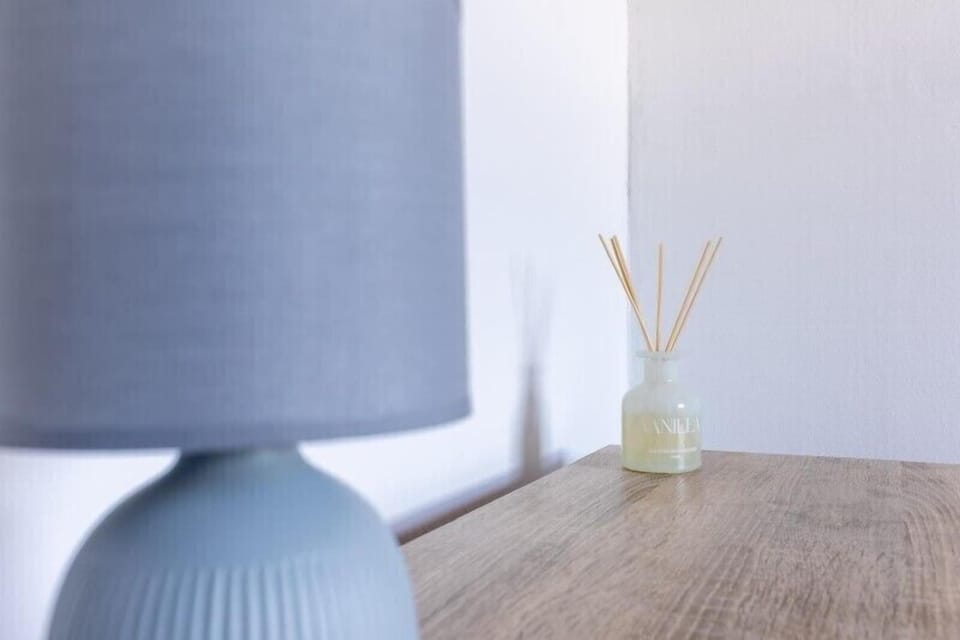 A cosy bedroom table illuminated by soft lighting, creating a warm and inviting atmosphere for relaxing stays.