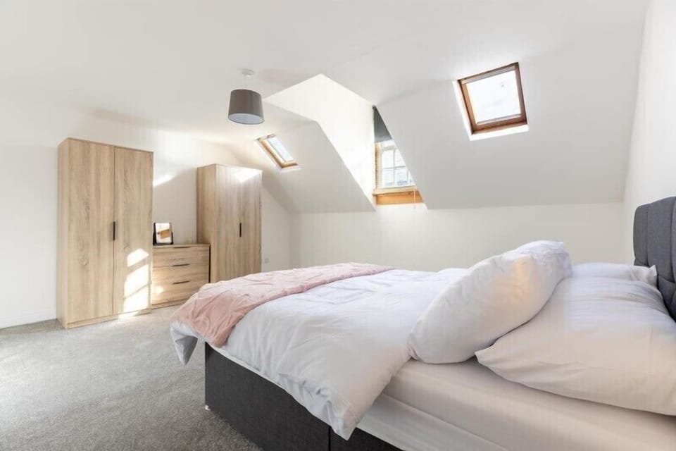 A cosy bedroom table illuminated by soft lighting, creating a warm and inviting atmosphere for relaxing stays.