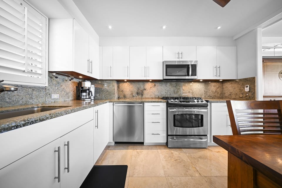 Prepare meals with ease in the refreshed kitchen featuring brand-new appliances, generous counter space, and a bright, functional layout.