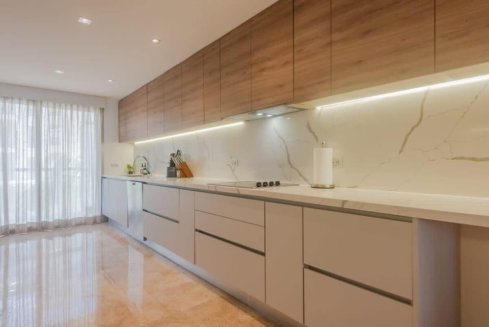 Cook with ease in a sleek, fully equipped kitchen featuring top appliances and ample space.