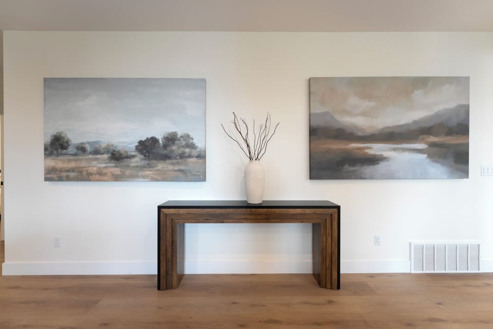 Thoughtfully curated artwork and elegant console styling create a refined, welcoming atmosphere as you enter your home.